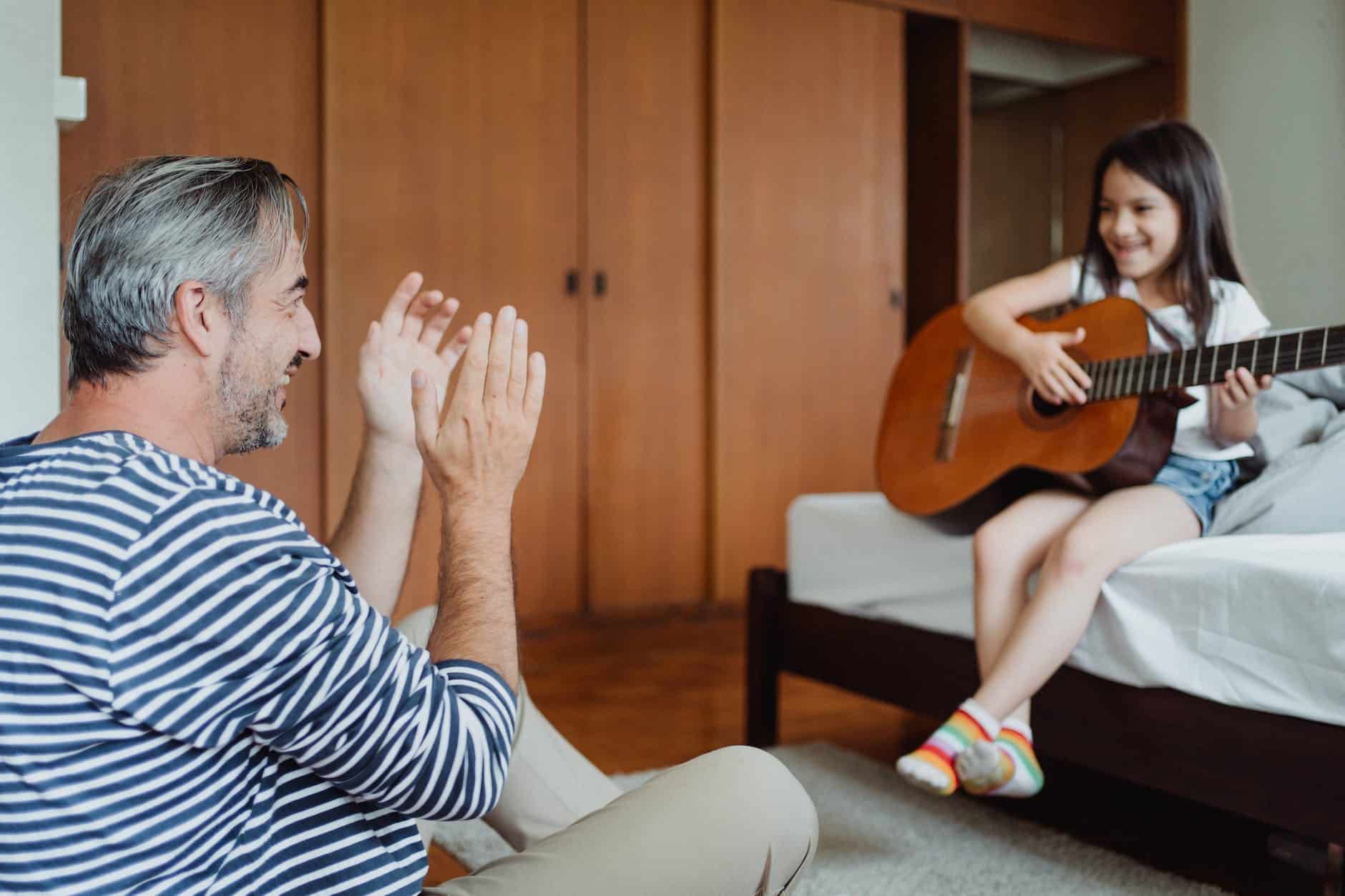kid guitar practice with her dad